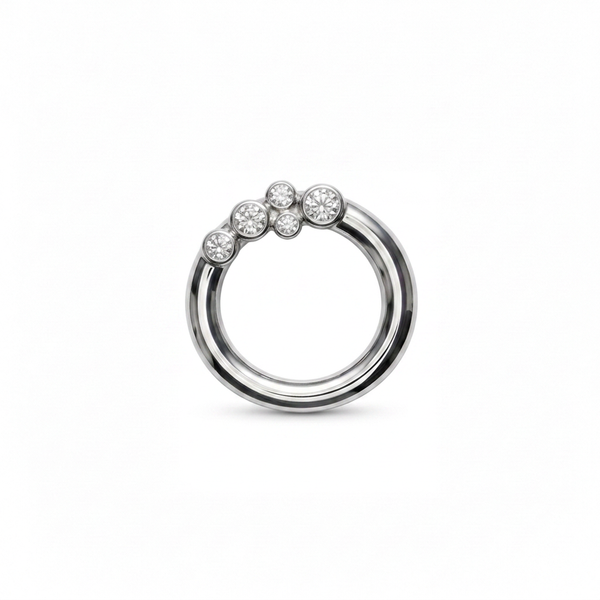 A silver pendant featuring a double-band design with a cluster of bezel set diamonds on the upper outer band, shown against a plain white background.