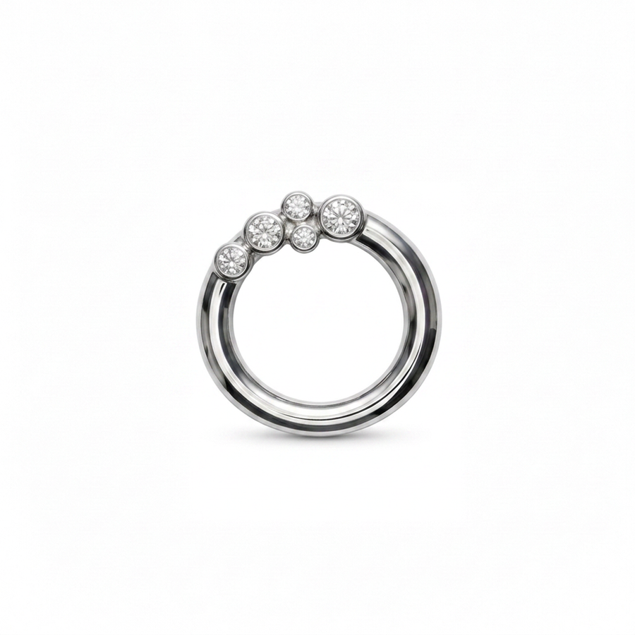 A silver pendant featuring a double-band design with a cluster of bezel set diamonds on the upper outer band, shown against a plain white background.