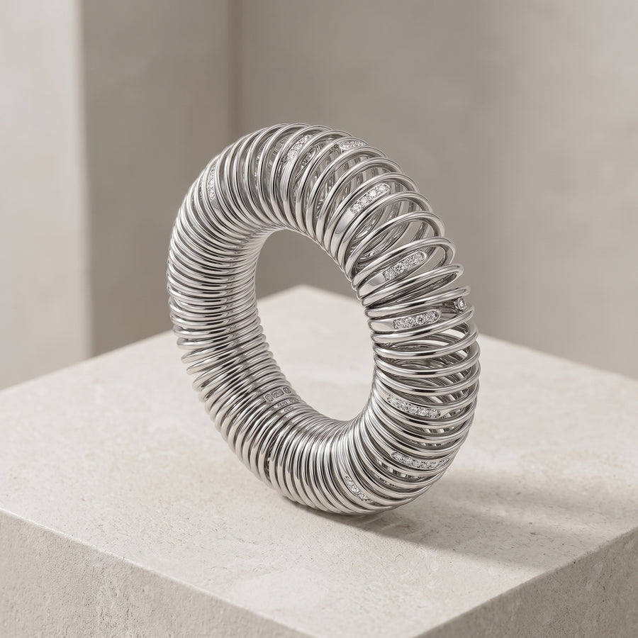 A silver bangle set with lab diamonds