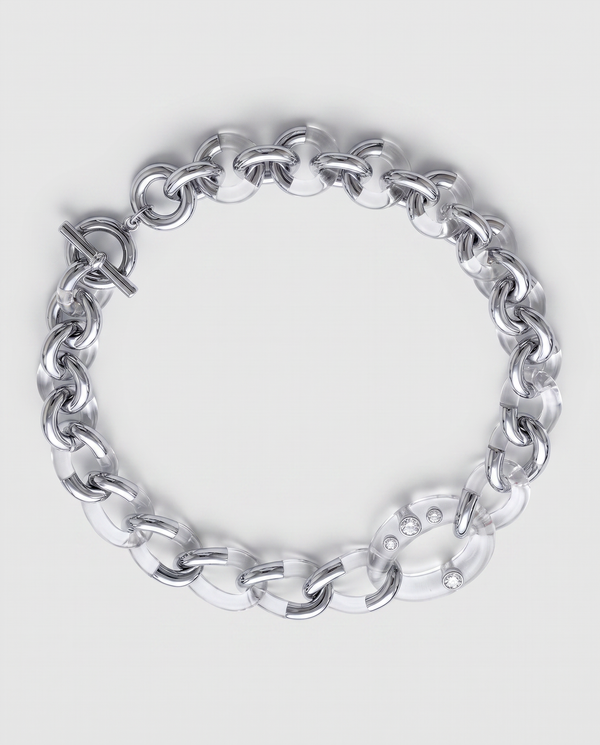 A chunky silver and resin chain link bracelet with a toggle clasp, photographed on a clean light gray background.