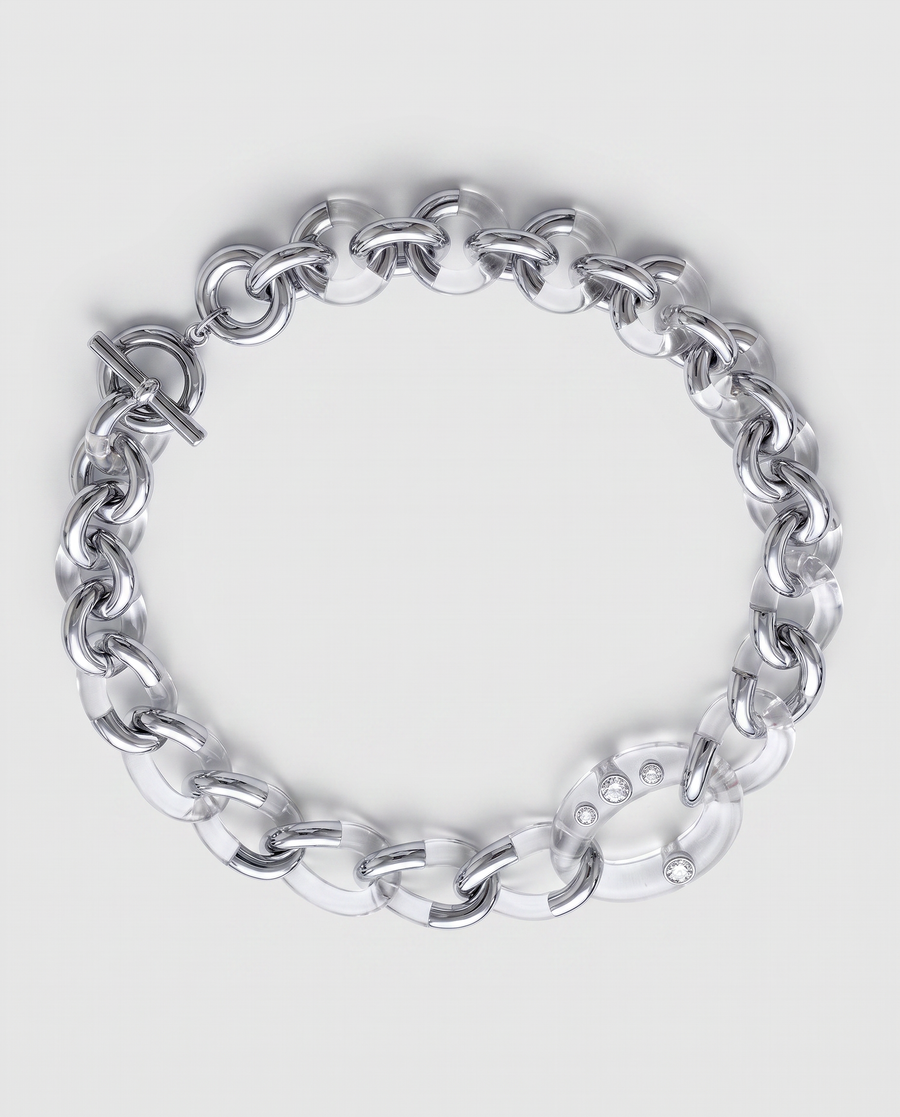 A chunky silver and resin chain link bracelet with a toggle clasp, photographed on a clean light gray background.