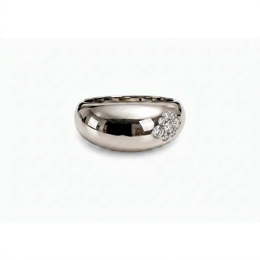 A polished silver band ring featuring a small cluster of diamonds on one side, set against a plain white background.